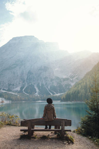 istock Girl sitting on Bench by Beautiful Lake 1088134728