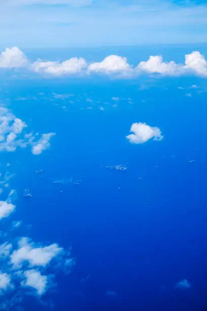 Aerial view of offshore oil rigs out at sea from mid-air