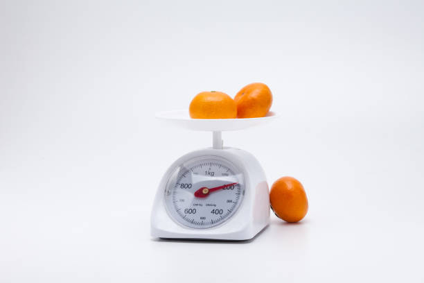 istock Healthy mandarin oranges on balance scale 1088140160