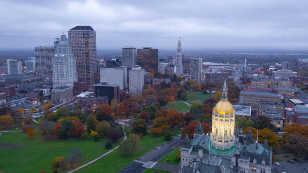 Hartford Connecticut Aerial View Capital Building Statehouse Downtown Dome lights come on under a dark sky at the Connecticut state capitol building in Hartford connecticut state capitol building stock pictures, royalty-free photos & images