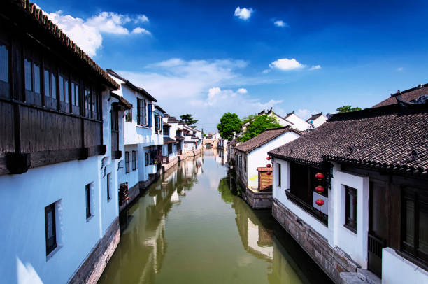 The white weathered buildings of the Luzhi Water Town scenic area in Wuzhong area of Suzhou China in Jiangsu Province on a sunny day.