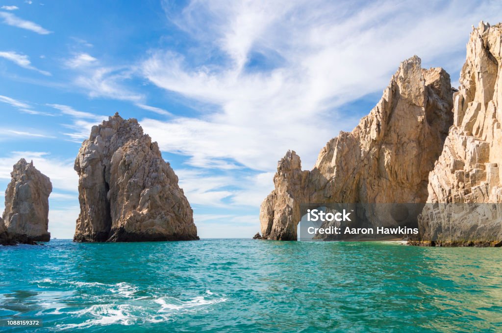 The Arch at Cabo San Lucas This is the world famous Arch rock formation in Cabo San Lucas, Mexico.  The Arch sits at the very tip of Baja California and is an obvious landmark for miles around.  The Arch is also a symbol of the Los Cabos region and creates a picturesque view at the meeting of the Pacific Ocean and Sea of Cortez. Cabo San Lucas Stock Photo