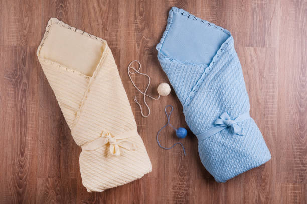 istock knitted blanket for newborns lying on a blue wooden surface 1088165262