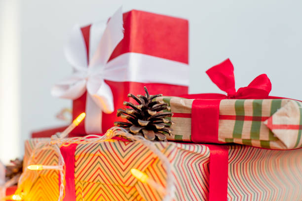 istock Female hands wrapping red christmas gift boxes 1088166748
