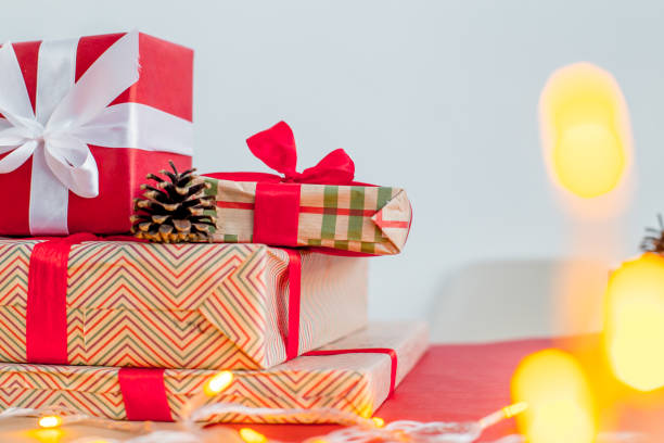 istock Female hands wrapping red christmas gift boxes 1088166754