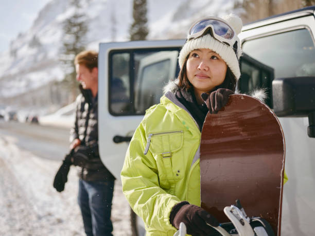 young adults enjoying a winter outing - skiing winter women snow imagens e fotografias de stock