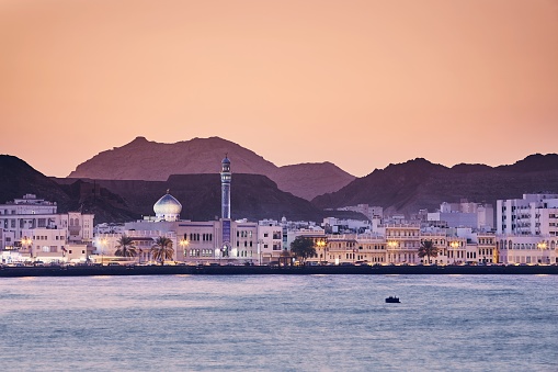 Cityscape view of Muscat city at golden sunset. The capital of Oman.