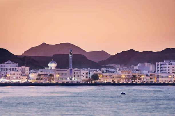 Muscat at golden sunset Cityscape view of Muscat city at golden sunset. The capital of Oman. islamic architecture photos stock pictures, royalty-free photos & images