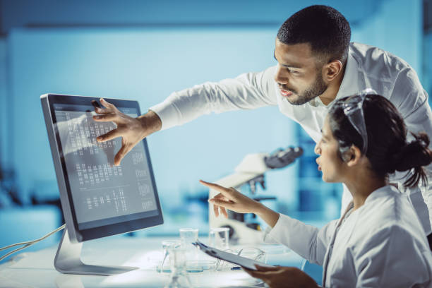 scientists working in the laboratory, using touch screen - laboratory pharmacy medicine research imagens e fotografias de stock