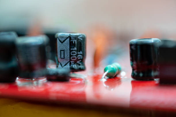 Close up (Macro) of Printed Circuit Board PCB embedded components (inductors, resistors, capacitors, diodes, microchips, transistor) with short depth of view.