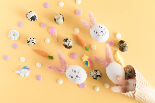 istock Happy Easter greeting card with copy space. Arrangement with colorful Easter eggs in waffle cone with place for text, isolated on pastel yellow background 1088203362