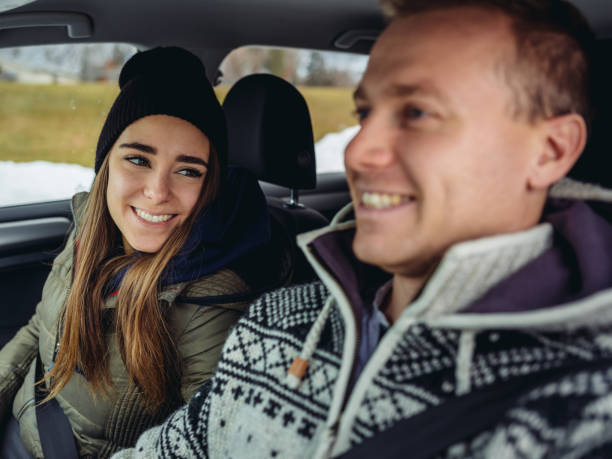 istock Millennial couple driving in a car in winter 1088205672