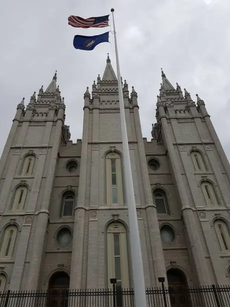 Salt Lake City Utah church facade with flags waving in the winds of the winter season in Salt Lake City, Utah, United States.
