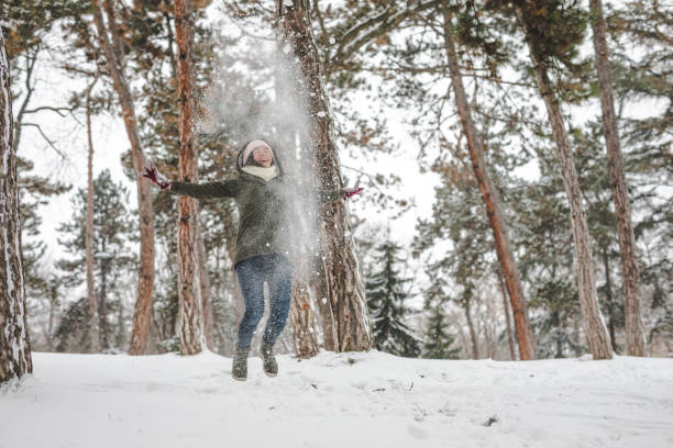 istock Young woman throwing snow 1088215062