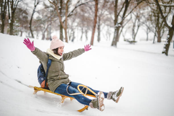 istock Young woman sledding downhill 1088215810