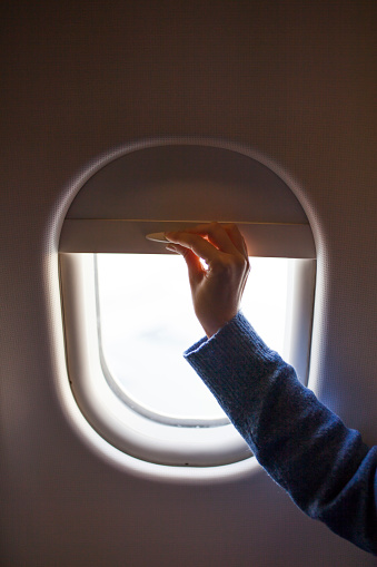 Opening window shades on plane