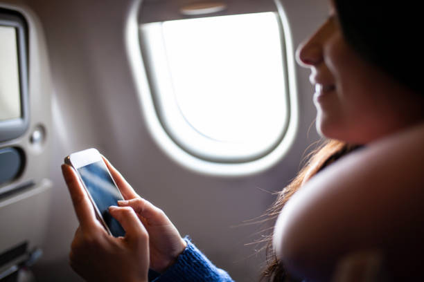 istock Woman texting on airplane before flight 1088225212