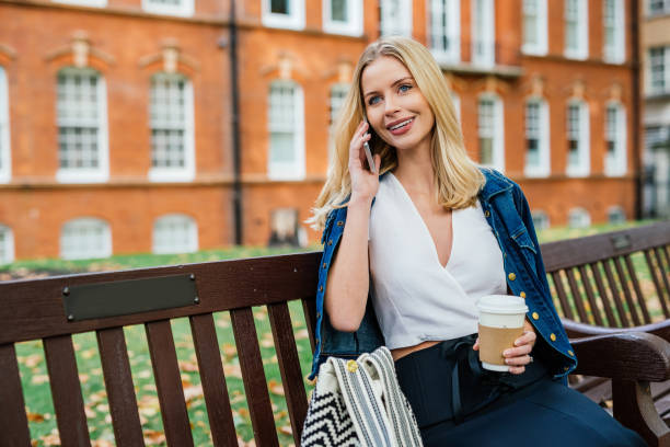 istock Cheerful British blond hair woman using phone for text messaging 1088226646