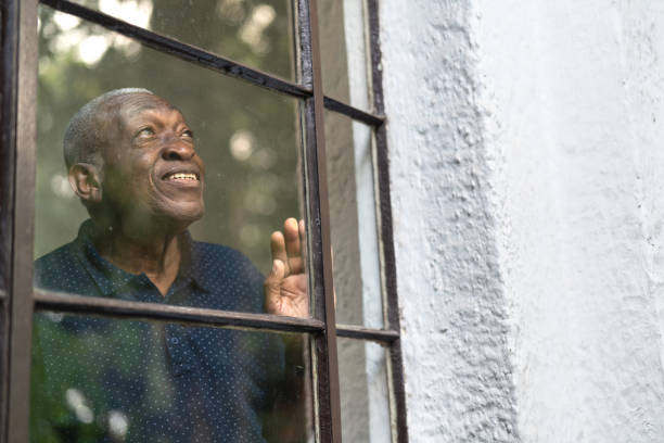 istock Afro Senior Man Looking Through The Window 1088226726