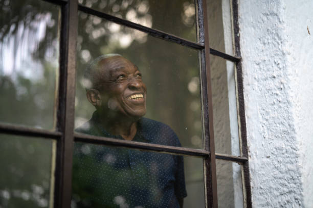 Afro Senior Man Looking Through The Window
