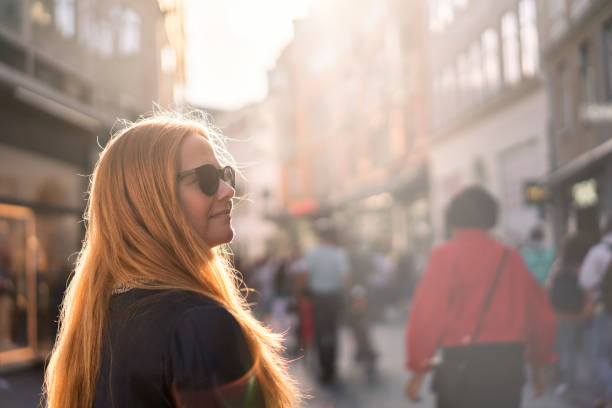 Female enjoying a sunny day in the city on a bright sunny day