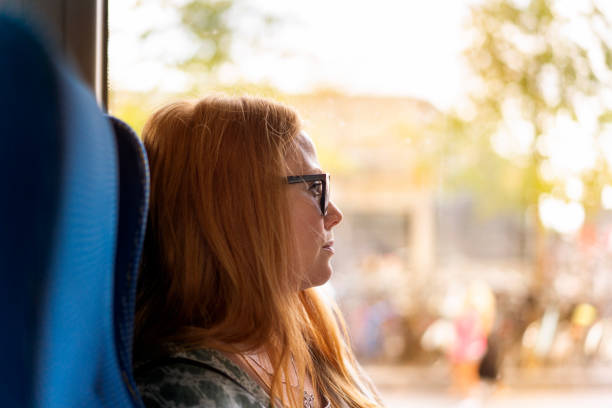 istock Woman on a bus looking out the window 1088230946