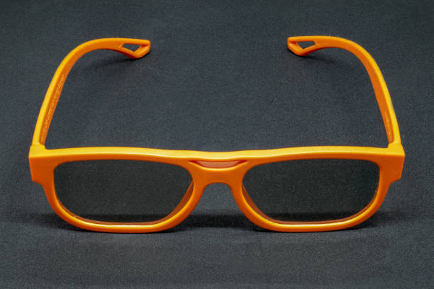 istock Orange 3D glasses on a dark grey background 1088231090