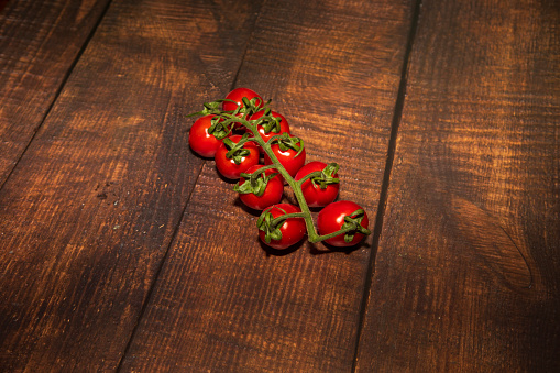cherry tomatoes on a wooden surface with natural light