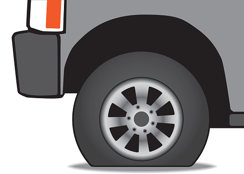A vehicle has a flat tire that needs inflating