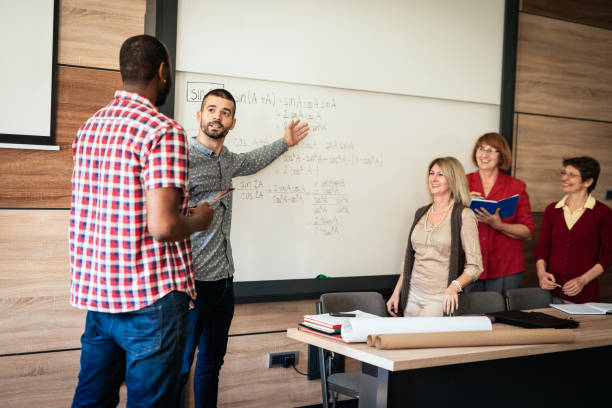 istock Adult and mature students on course with professor 1088239988