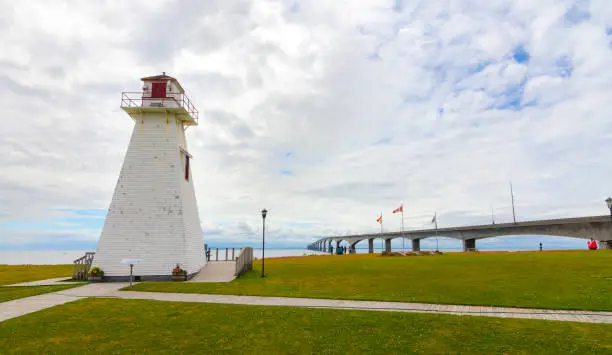 Photo of Lighthouse in the park.  Warm muggy day in PEI.  New Brunswick Confederation Bridge in distance.