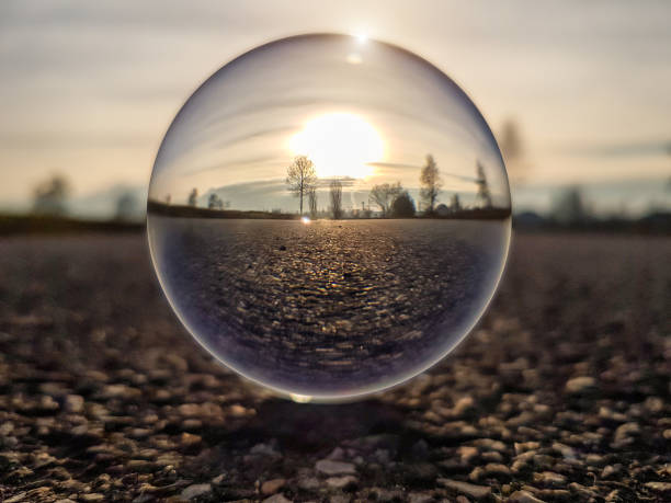 Sunset on a country road through a lens ball (crystal ball) - Italy Sunset on a country road through a lens ball (crystal ball) - Italy fish eye lens photos stock pictures, royalty-free photos & images