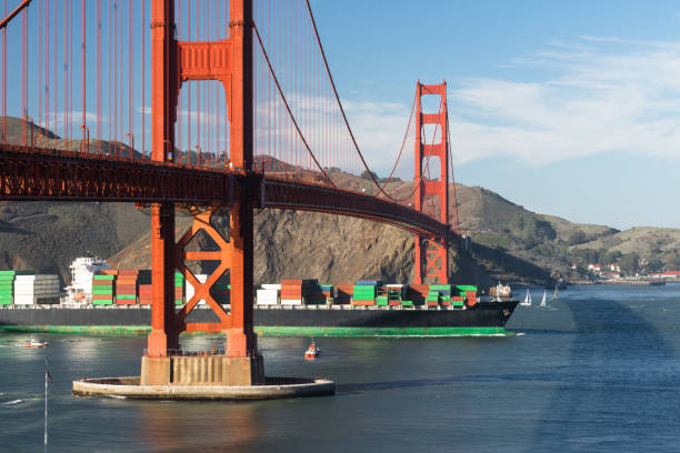 Container Ship Brings Imported Products Golden Gate Bridge San Franciso California The harbor pilot boat guides this large container cargo ship into Sanfrancisco Bay under the Golder Gate Bridge san francisco county city california urban scene stock pictures, royalty-free photos & images