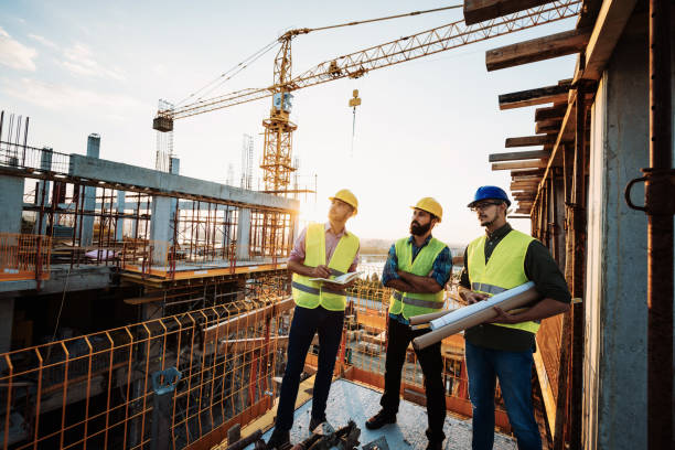 istock Photo of large scale construction site with engineers and construction workers 1088252832