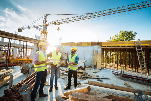 istock Photo of large scale construction site with engineers and construction workers 1088253472
