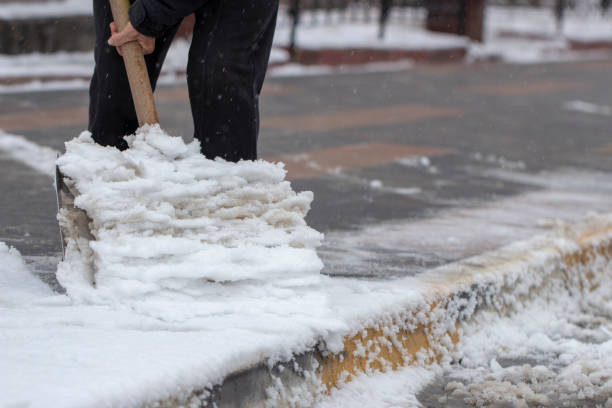 istock Man with snow shovel cleans sidewalks in winter. 1088256482