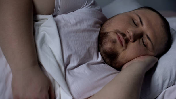istock Closeup of chubby man sleeping peacefully, relaxing on comfortable mattress 1088258082
