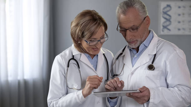 istock Therapists team looking at tablet, using modern app, technologies in medicine 1088258408