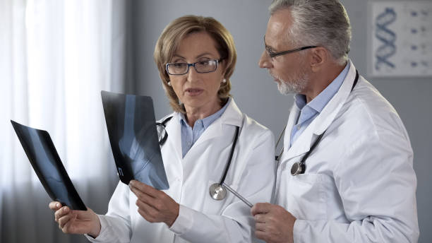 istock Experienced doctors discussing methods of treatment, comparing x-rays of joints 1088258520