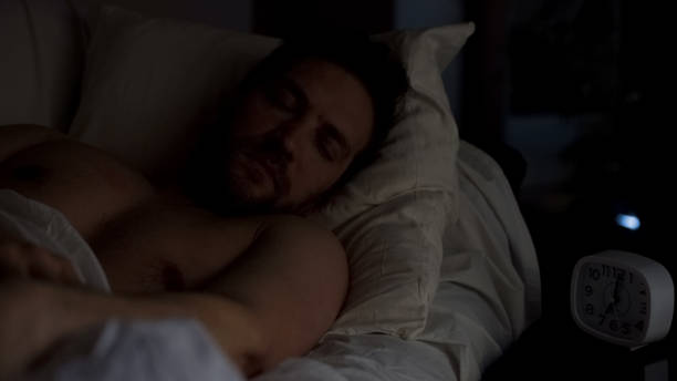 istock Mid-aged male sleeping deep in bed, comfortable bedding and mattress, relaxation 1088258654