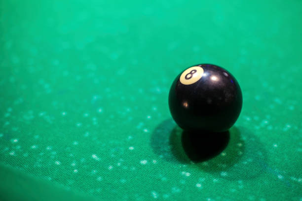 istock black billiard ball on the table, number 8 1088260454