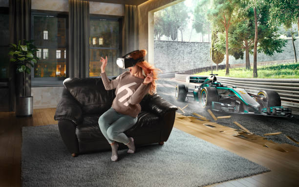 Woman in VR Glasses. Virtual Reality with racing cars on the track Beautiful woman at home on a black sofa with VR headset emotionally racing in car on the track in virtual reality extreme sports technology stock pictures, royalty-free photos & images