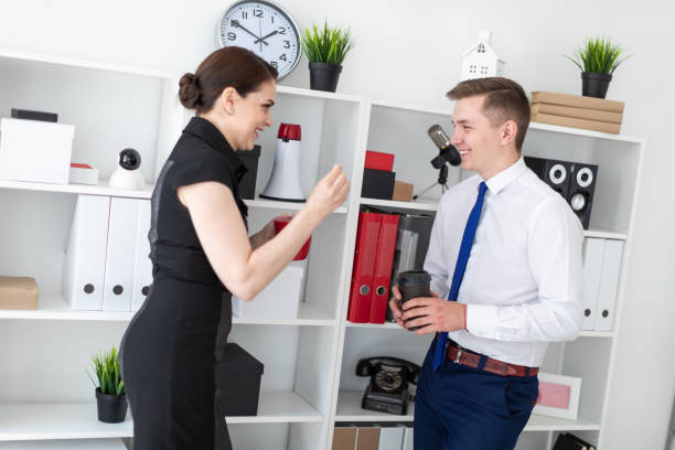 istock Young people in the office standing near the rack with documents and drink coffee. 1088263110