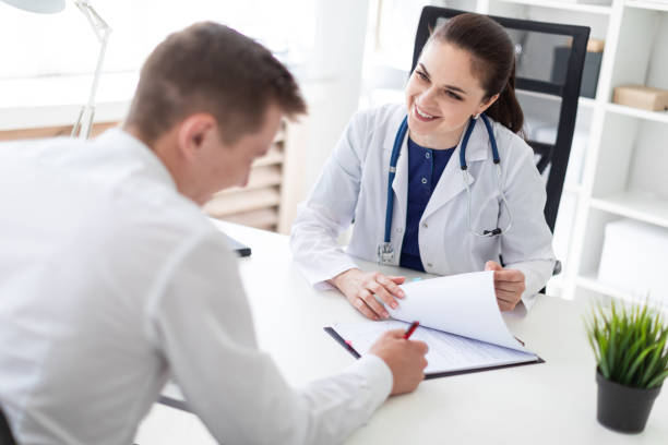 istock The young man at the doctor's office signs the documents. 1088263116