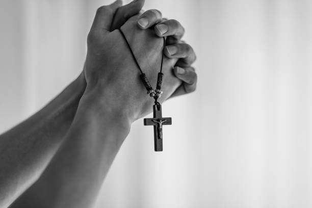 istock Praying hands holding a rosary. 1088263260