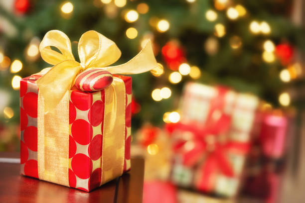 istock Red and golden Christmas present with a bow and an ornament 1088302324