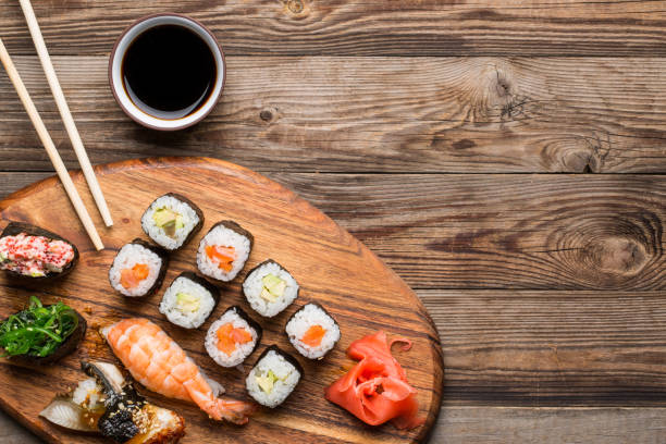 istock Sushi, rolls and spices on wooden light brown background 1088331964