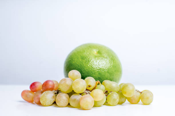 Creative layout made of fruits on a white background grape coconut kiwifruit