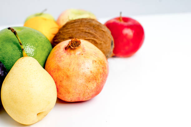 background made of several fruits: apples, oranges, lemons and pears. Narrow deep of field.