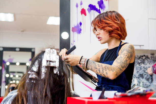 istock Professional hairdresser working with client in salon 1088337352